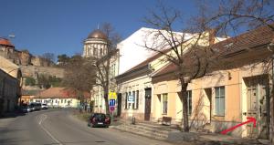 a street in a town with a clock tower at Romantic and relax in Esztergom