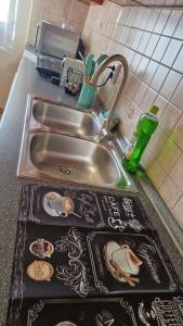 a kitchen counter with a sink and a counter top with a tray at Jackpot Apartman in Budapest