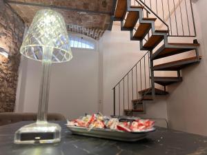 a table with a plate of food and a lamp at Dal Prof in Sulmona