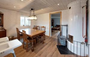 a kitchen and dining room with a table and chairs at 3 Bedroom Beautiful Home In Lönashult in Lönashult