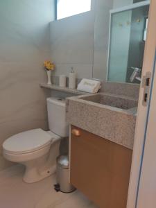 a bathroom with a toilet and a sink at Luar Porto de Galinhas in Porto De Galinhas