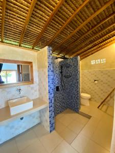 a bathroom with a sink and a shower and a toilet at Abdi Fantastik in Gili Air