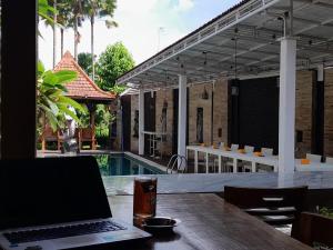 a laptop computer sitting on a table next to a pool at North Wing Canggu Resort in Dalung