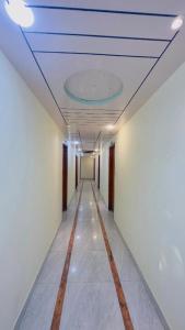 a hallway with a blue ceiling and a long corridor at Hotel Shah Nibash Panthapath in Dhaka