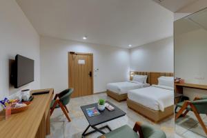 Postel nebo postele na pokoji v ubytování Comfort Inn Sapphire Chandkheda, Ahmedabad + 18 fotografií