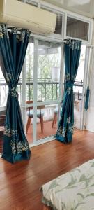 un par de cortinas azules en una habitación en H2_Homestay phố cổ _Check in tự động, en Hanói