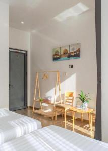 a bedroom with a bed and a table and a chair at TTG Hostel DaLat in Da Lat