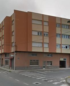 an apartment building on the corner of a street at Mingos in Arzúa