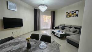 a living room with a couch and a table at Nice 2 bedroom Al Marjan island near the beach in Ras al Khaimah