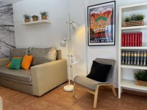 a living room with a couch and a chair at Apartamentos Inside Casa de la Alberca in Granada