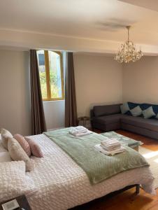 a bedroom with a bed and a couch at The Soulful Retreat in Héres