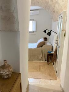 A bed or beds in a room at Trullo Falco