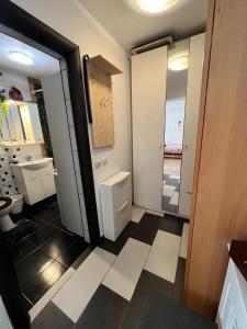 a bathroom with a toilet and a sink and a mirror at Magician’s House with it’s own parking in Bucharest