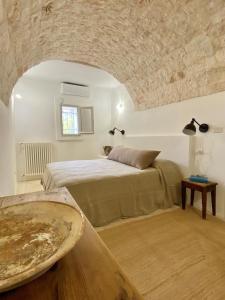 A bed or beds in a room at Trullo Falco