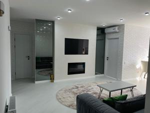 a living room with a couch and a fireplace at Apartment 2 bedrooms in Chişinău