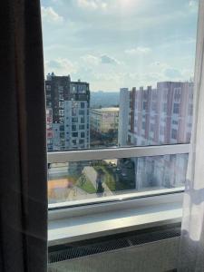 a window with a view of a city at Apartment 2 bedrooms in Chişinău