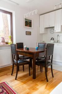 a dining room table and chairs in a kitchen at Pink Rose Suite in Józefów