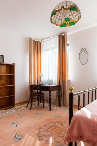 a bedroom with a piano and a bed with a window at Pink Rose Suite in Józefów