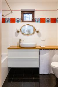 a bathroom with a sink and a mirror at Pink Rose Suite in Józefów