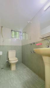 a bathroom with a toilet and a sink at Hotel Shah Nibash Panthapath in Dhaka