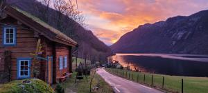 a house on the side of a road next to a lake at Preikestolen in Forsand +41 photos