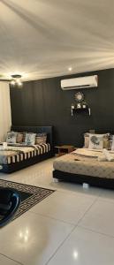 a room with two beds and a black wall at Ksl D'Esplanade Studio Apartment's 2 in Johor Bahru
