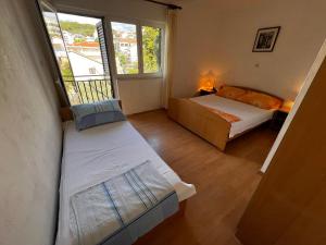 Postel nebo postele na pokoji v ubytování Apartmani Leila