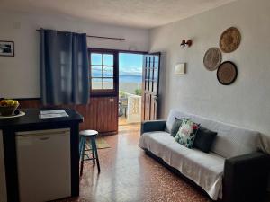 a living room with a couch and a view of the ocean at Casa Los Palitos in Monte de Breña