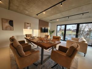 a dining room with a table and chairs at SiOUX: stilvolles Designapartment am Bodensee in Lindau-Bodolz +24 photos