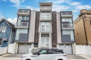 a white car parked in front of a house at Stylish Chic Condo NYC at Fingertips in North Bergen