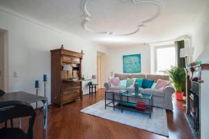 a living room with a couch and a table at Charming apartment w/courtyard in historical house in Lugano