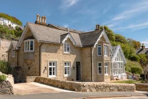 an old stone house with white windows at Jaw-dropping view over the English Channel in Wroxall