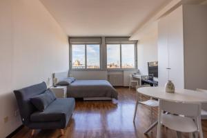 um quarto com uma cama, uma secretária e uma mesa em Paolo Fabbri Apartment em Bolonha