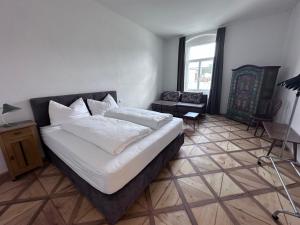 a bedroom with a bed and a living room at Rilke Apartments in Linz
