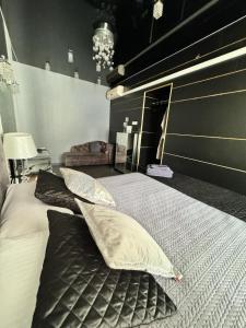 a bedroom with a bed with two pillows on it at EVIS LTD apartments 1 in Rēzekne