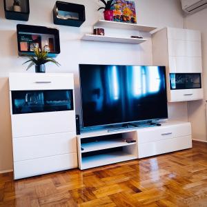 a large white entertainment center with a flat screen tv at Apartman Selska in Zagreb