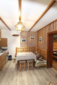 a dining room with a table and a kitchen at Будиночок для щастя in Yaremche