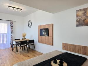 a bedroom with a table and a dining room at Willa Sowia nowe apartamenty nad górskim potokiem zachwycający widok na góry in Stronie Śląskie +39 photos