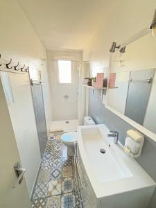 a bathroom with a sink and a toilet and a shower at Studio Centre Plage parking gratuit in Collioure +40 photos