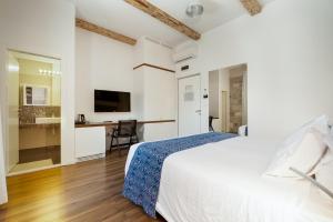 a white bedroom with a bed and a desk at Azur Palace Luxury Rooms in Split