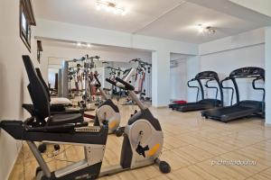 a gym with several treadmills and exercise bikes at Arkasa Bay Hotel in Arkasa