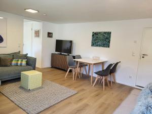 a living room with a couch and a table at ammersee apARTment Dießen in Dießen am Ammersee