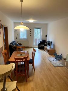 a living room with a table and chairs and a couch at Apartmán pod Prokopem in Železná Ruda