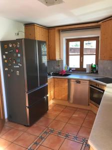 a kitchen with a stainless steel refrigerator at Family-Place-Mountain View-Fireplace-8 P. in Lenggries