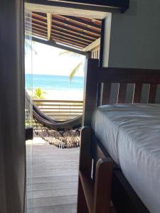 a bedroom with a bed and a view of the beach at Tabatinga Beach Hotel in Nísia Floresta