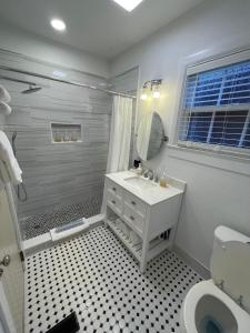 a white bathroom with a sink and a mirror at Historic Tapoco Lodge in Tapoco