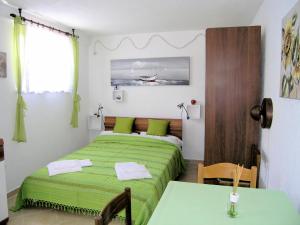 two beds in a small room with green sheets at Studio Apartment Tamara in Krk