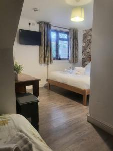 a bedroom with a bed and a window at The mill wheel in Hartshorne