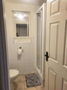 a bathroom with a toilet and a window and a door at The mill wheel in Hartshorne