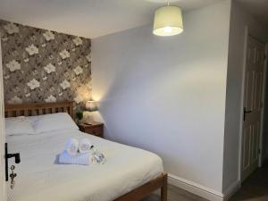 a bedroom with a bed with two towels on it at The mill wheel in Hartshorne